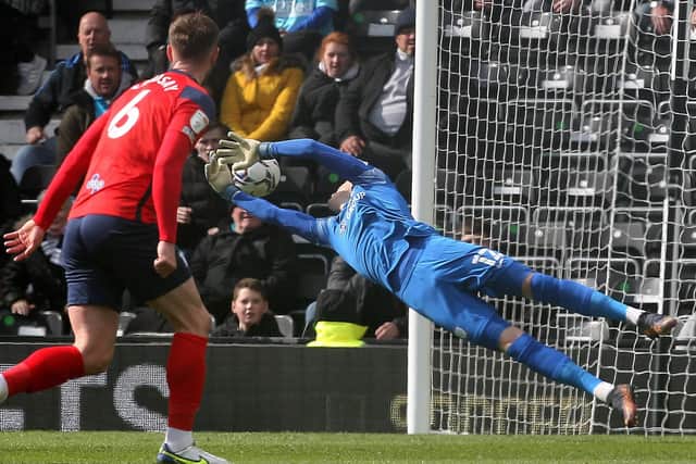 Daniel Iversen dives to save in Preston North End's game at Derby