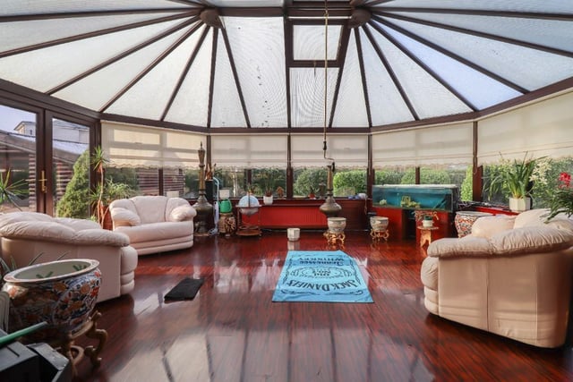 The living room leads on to the large conservatory.