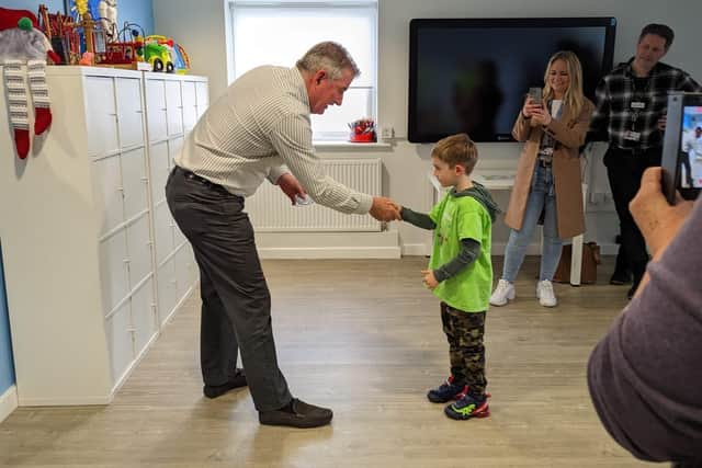 Mark Dunn shakes Oscar’s hand (Derian House Children’s Hospice/PA)