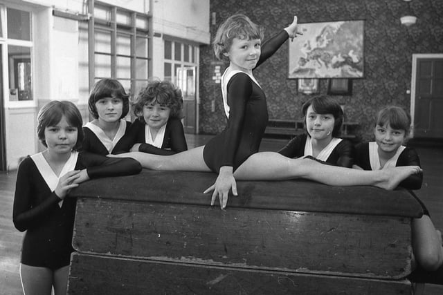 The winning Preston and District Primary Schools champion gymnastics team of Roebuck look on as individual champion Susan Aspinall shows her style. Pictured (left to right) are Janette Livesey, Karen Norris, Angela Binning, Susan, Pamela Flood, and Donna Douglas
