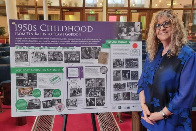 Pat Harrison pictured with one of the exhibition boards