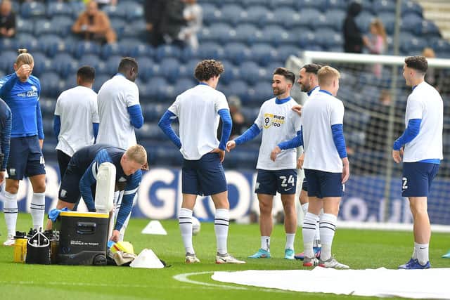 Preston North End players warm up at Deepdale.