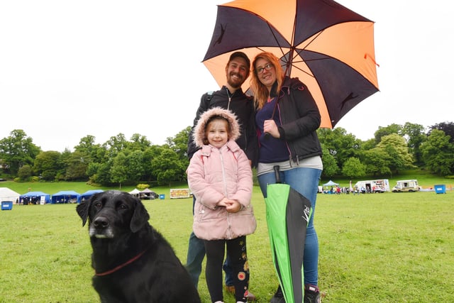 Lee Coombe, Jen Roberts, Ella Roberts, five, and Archie the dog, brave the rain to see the entertainment