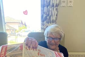 Resident Margaret Donnelly at HC-One’s Dove Court Care Home interacting with Boots memory box