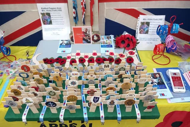 John’s stand features a range of RBL products, including poppy crosses with the emblems of all the UK regiments, and some of Violet’s knitted poppies