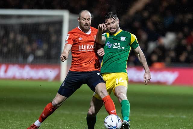 Preston North End defender Andrew Hughes competes with Luton Town's Danny Hylton