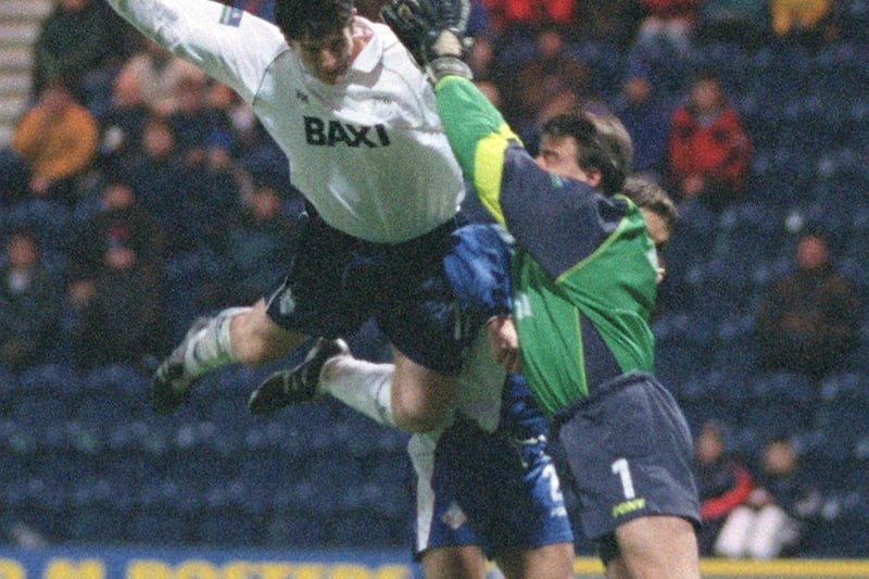 Preston's Jon Macken climbs against Oldham's keeper Gary Kelly