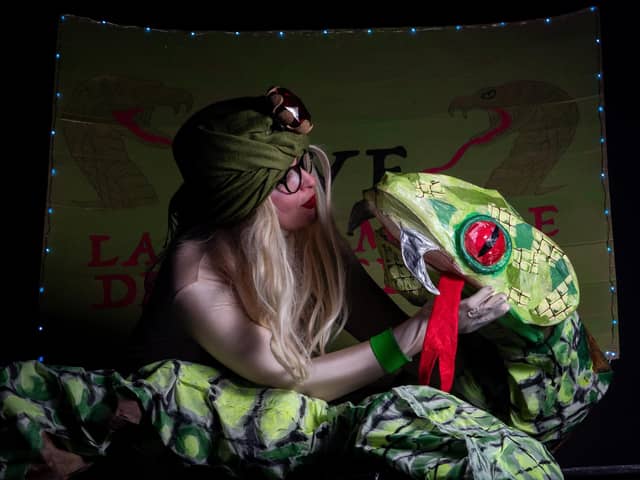 Pictured is Ruth Collinge as Eve the Snake Charmer