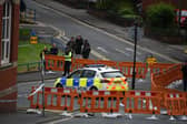 Police cordon off the area while the demolition work begins
