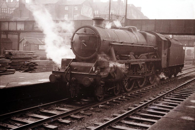 Preston Raiway Station. December 10, 1960
No. 45643 at platform 4.

Of interest is a view of the old parcel bridge that connected platforms 1-5 to the station approach. This bridge facilitated the delivery of parcels and luggage directly to the platforms without the need to take the rather circuitous route of using the subways ramps and stairs. Hydraulic lifts serviced each of the three main platform islands. The layout can be seen on the map below (see related images) The bridge was out of use by the late 1950's and was removed in the early 1960's

Courtesy and copyright of Tony Gillett ©
