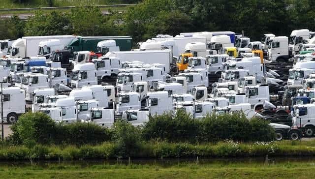 Dozens of lorries have been parked up at Botany Bay since January, while they await microchip components - but that arrangement will now be "pahsed out"
