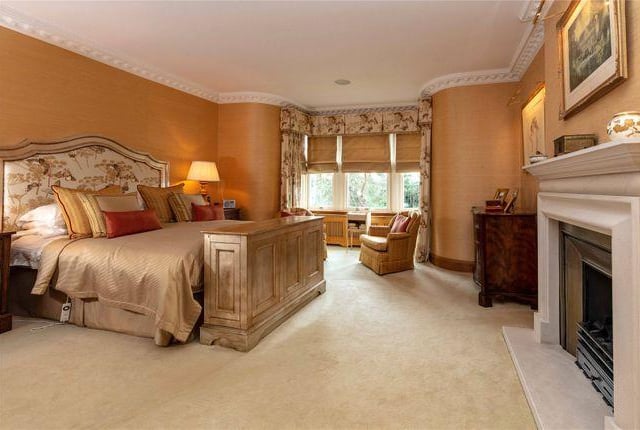 This grand bedroom boasts its own fireplace, bay windows, an en suite and space for a massive bed.