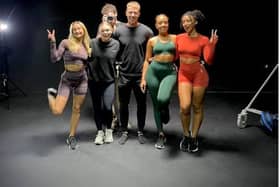 Owner and director of online gymwear clothing Pursue Fitness Michael Hughes, 29, pictured with some of the sportswear models