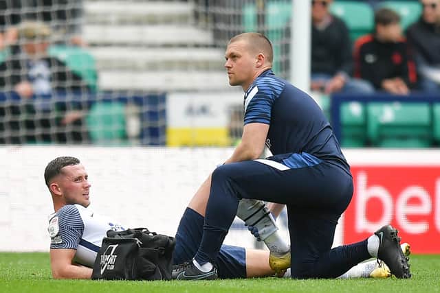 Preston North End skipper Alan Browne receives treatment from physio Matt Jackson during the game against Millwall