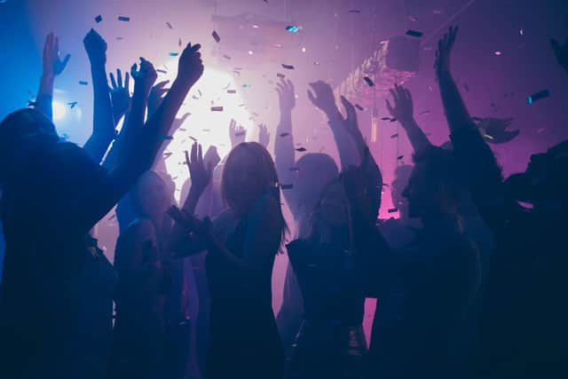 Party people dancing. Photo: Adobe
