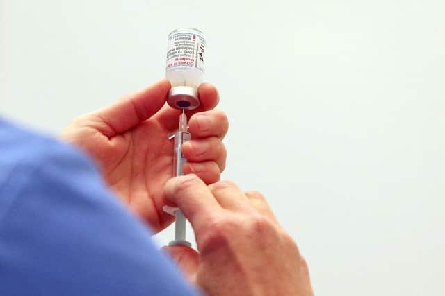 A vial of the Moderna Covid-19 vaccine is prepared at the Madejski Stadium in Reading, west of London on April 13, 2021. (Photo by Steve Parsons / POOL / AFP) (Photo by STEVE PARSONS/POOL/AFP via Getty Images)