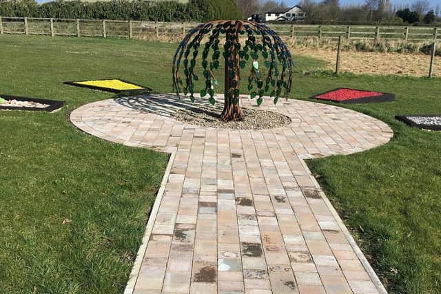 The steel tree at the heart of the garden is surrounded by four scatter beds to represent the four seasons.
