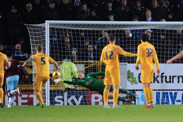 Preston North End's Jordan Pickford dives to his right to keep out a free kick taken by Burnley’s Joey Barton