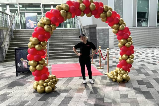 Kelly Wild of Exquisite Balloons with the balloon arch she created for the BBC children's show 'Odd Squad'