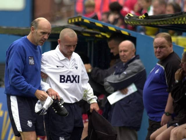Mick Rathbone helps Paul McKenna off the pitch during his time as Preston North End physio