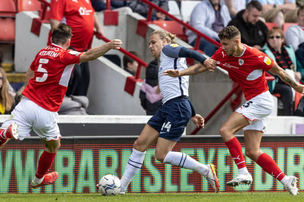 Preston North End wing-back Brad Potts competing with Barnsley's Liam Kitching and Matty Wolfe