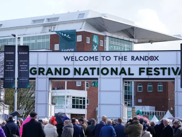 Racegoers queue at Aintree Racecourse, ahead of the opening day of the Randox Grand National Festival