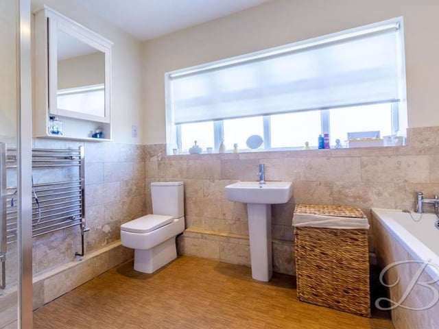 The modern and stylish family bathroom is beautifully appointed. It is fitted with a white suite, comprising panelled bath, shower cubicle, low-level WC and wash hand basin.