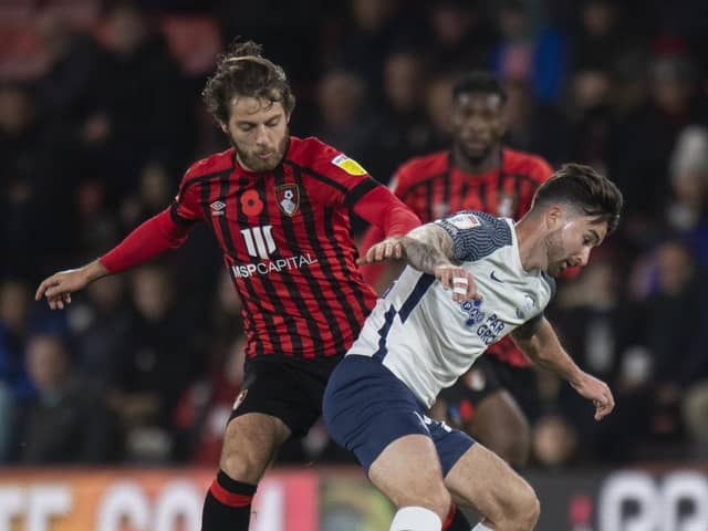 Bournemouth midfielder Ben Pearson battles with Preston North End striker Sean Maguire at the Vitality Stadium