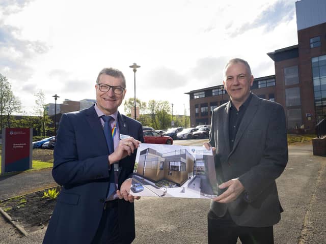 UCLan's Professor Graham Baldwin and Morgan Sindall's Richard Potts. They are holding up a picture of the planned new building in front of the current building.