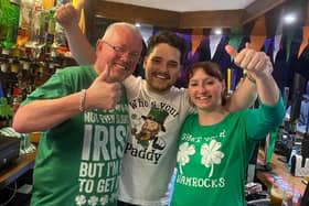 Martin Maughan (centre) the owner of The Coal Clough pub in Burnley celebrates St Patrick's Day with two customers. Martin has started a new initiative at the pub offering free food and a hot drink to the homless and vulnerable on Monday afternoons