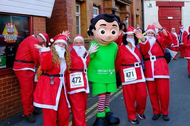Some of the Santas who took part in the event with the Derian House mascot