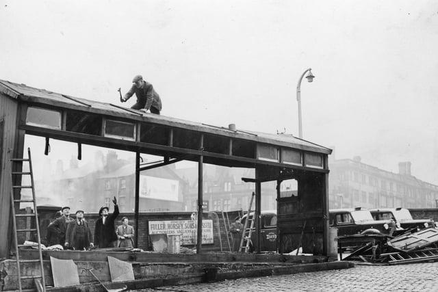 It took just three hours for this Preston landmark, known to hundreds of thousands of railway passengers since the 1880s to be knocked down in 1961. It was built as a shelter for the town's old drivers with their horse-drawn vehicles. Later it became a welcome shelter for cabbies. The hut was still in use the night before this demolition work took place