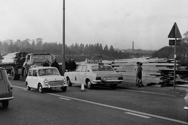 All neatly stacked up at the side of the road is a huge transport of wood which was left strewn over Leyland Road in Penwortham. Traffic was held up by police road blocks during the incident in 1962
