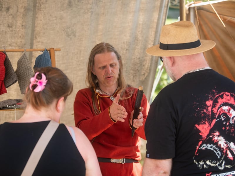 Heysham Viking Festival 2026 - a Viking explaining a weapon or object to festivalgoers.