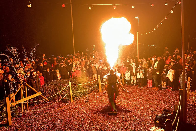 Visitors watch the spectacular fire show