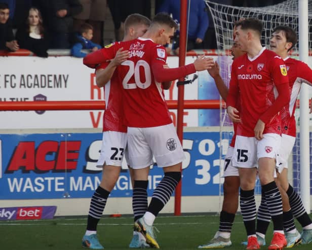 Morecambe celebrate Liam Shaw's goal. (Photo: Ian Lyon)