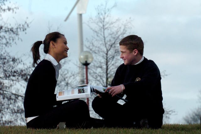 Santi Lopez and Banyin Costello discuss renewable energy near the wind turbine at Ashton High School in 2006
