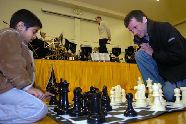 Malcolm Peacock, secretary of Preston Chess Club, with Krishna Navekar, aged six, at Preston Hobbies Fair held at the Gujarat Hindu Society