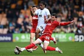 Callum Jones tackles Port Vale's Rhys Walters Picture: Gareth Copley/Getty Images