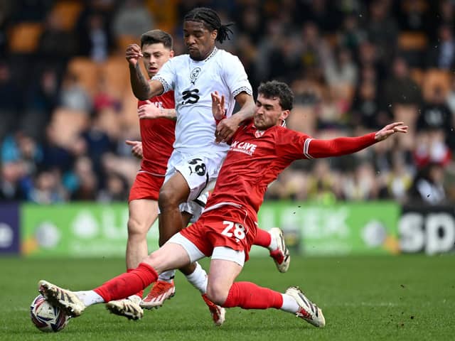 Callum Jones tackles Port Vale's Rhys Walters Picture: Gareth Copley/Getty Images