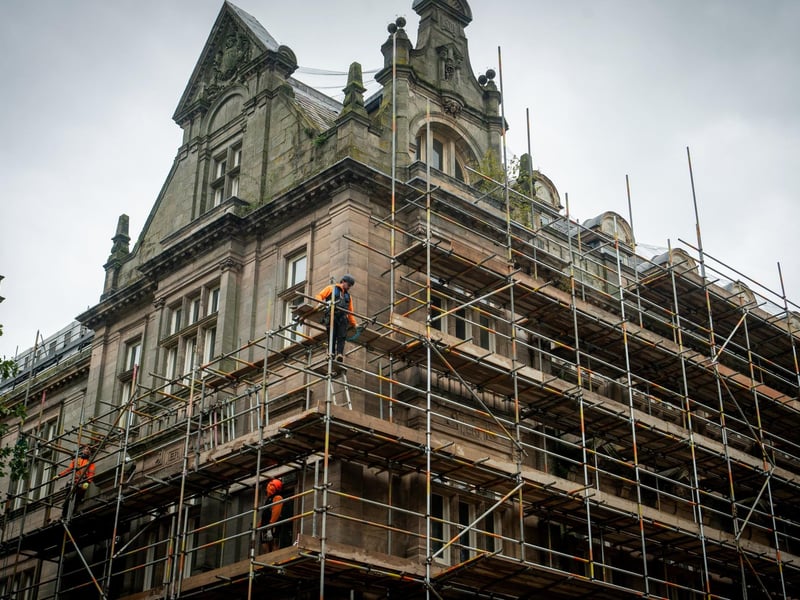 Workmen erecting scaffolding on the former Post Office building in Preston City Centre
