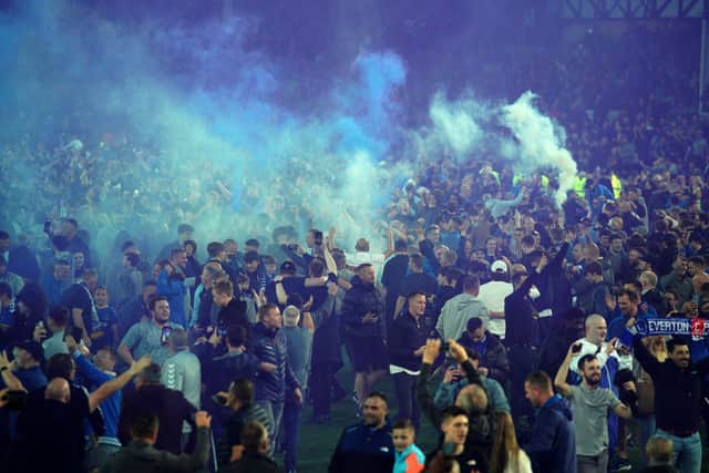 Everton fans celebrate on the pitch after their Premier League victory over Crystal Palace at Goodison Park