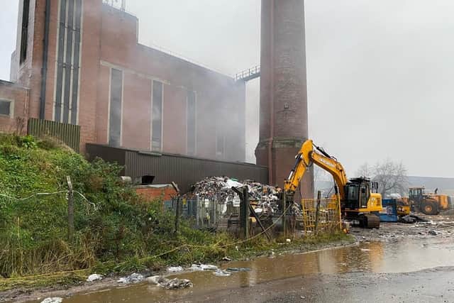 Outbuildings are having to be demolished at the former Supaskips site in Lancaster to allow firefighters greater access to the fire which is still smouldering.