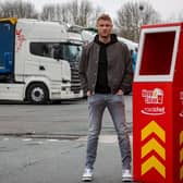 Freddie Flintoff poses next to an extra tall bin for lorry drivers
