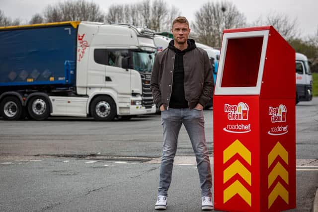 Freddie Flintoff poses next to an extra tall bin for lorry drivers