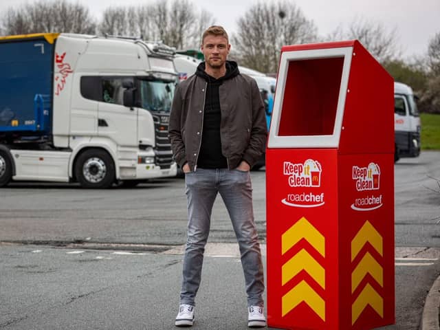 Freddie Flintoff poses next to an extra tall bin for lorry drivers