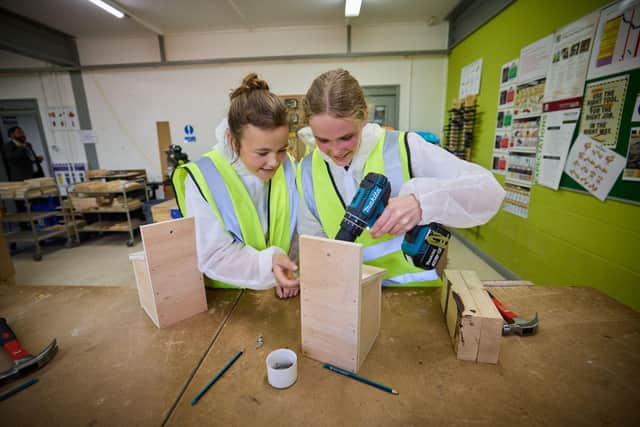 Girls building bird boxes at the event