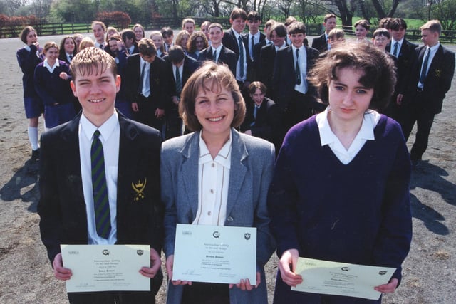 Pioneering pupils at All Hallows RC High School have proved they are top of the class by completing a new qualification. Youngsters from the school have been working towards GNVQs, something usually reserved for college students. Pictured is Ann McDonald with James Sawyer and Emma Maddox and the rest of the All Hallows students who have gained the qualification