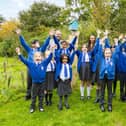 Teacher Mr Hanson with Redrow's Fran Kent and pupils from Sherwood Primary School