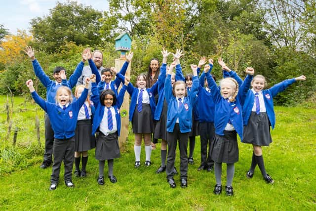 Teacher Mr Hanson with Redrow's Fran Kent and pupils from Sherwood Primary School